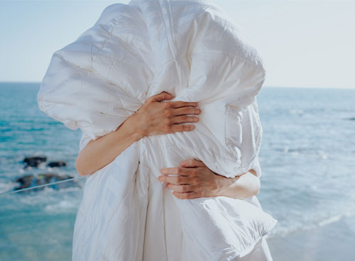 arms squeezing a comforter