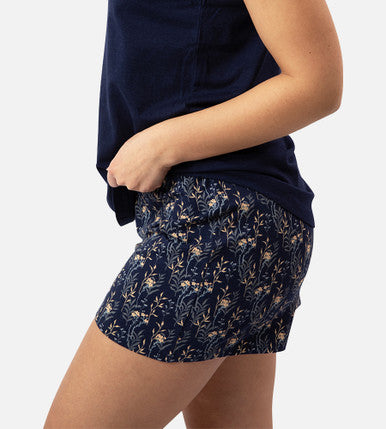 side view of models legs wearing midnight floral print sleep shorts