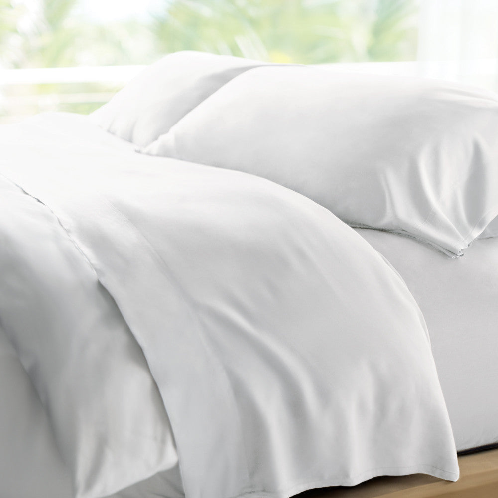 bed made with white retreat sheets