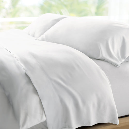 bed made with white retreat sheets