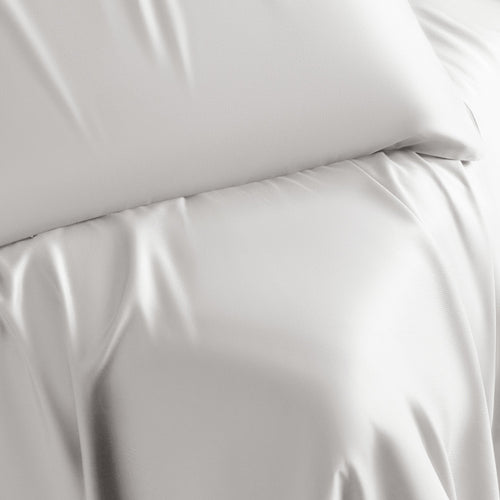 close-up on bed made with white retreat sheets