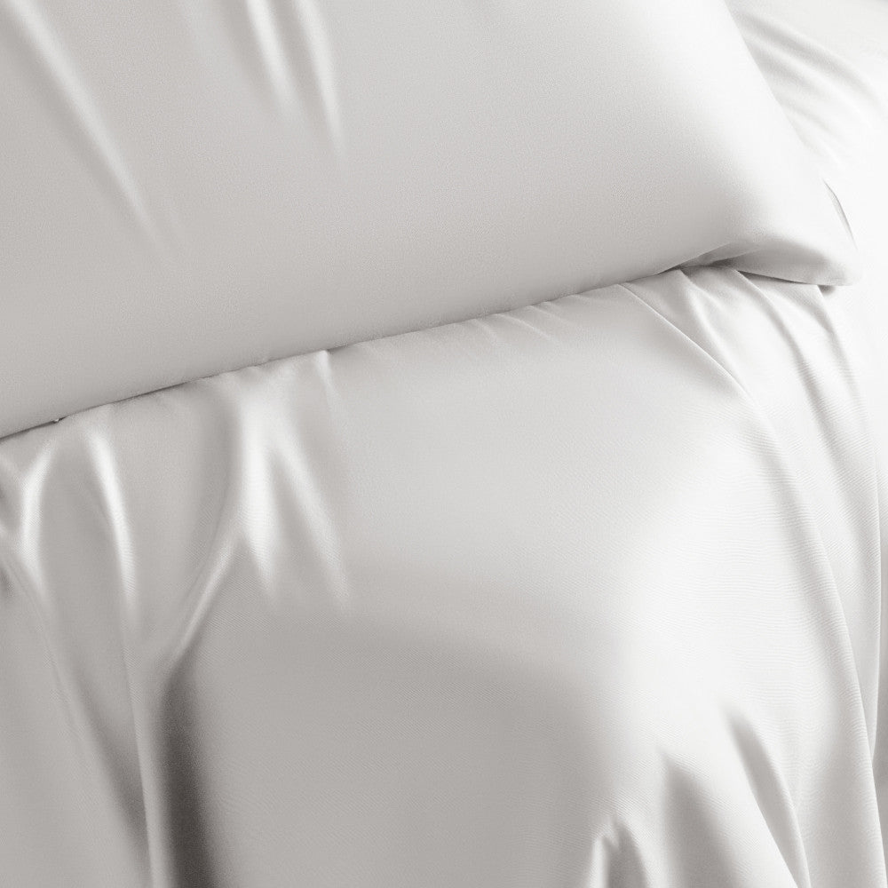 close-up on bed made with white retreat sheets~White