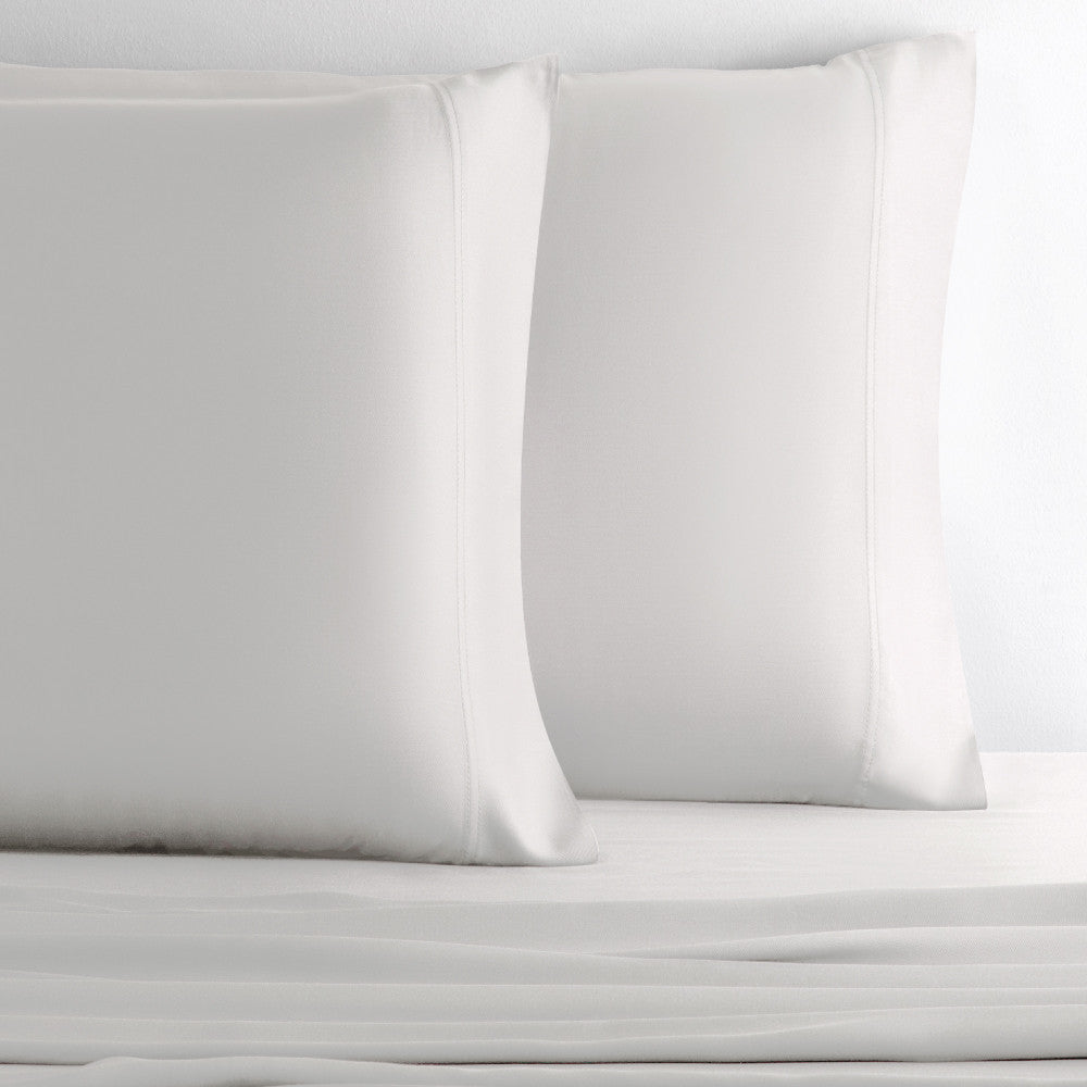 two pillows with black sand pillowcases