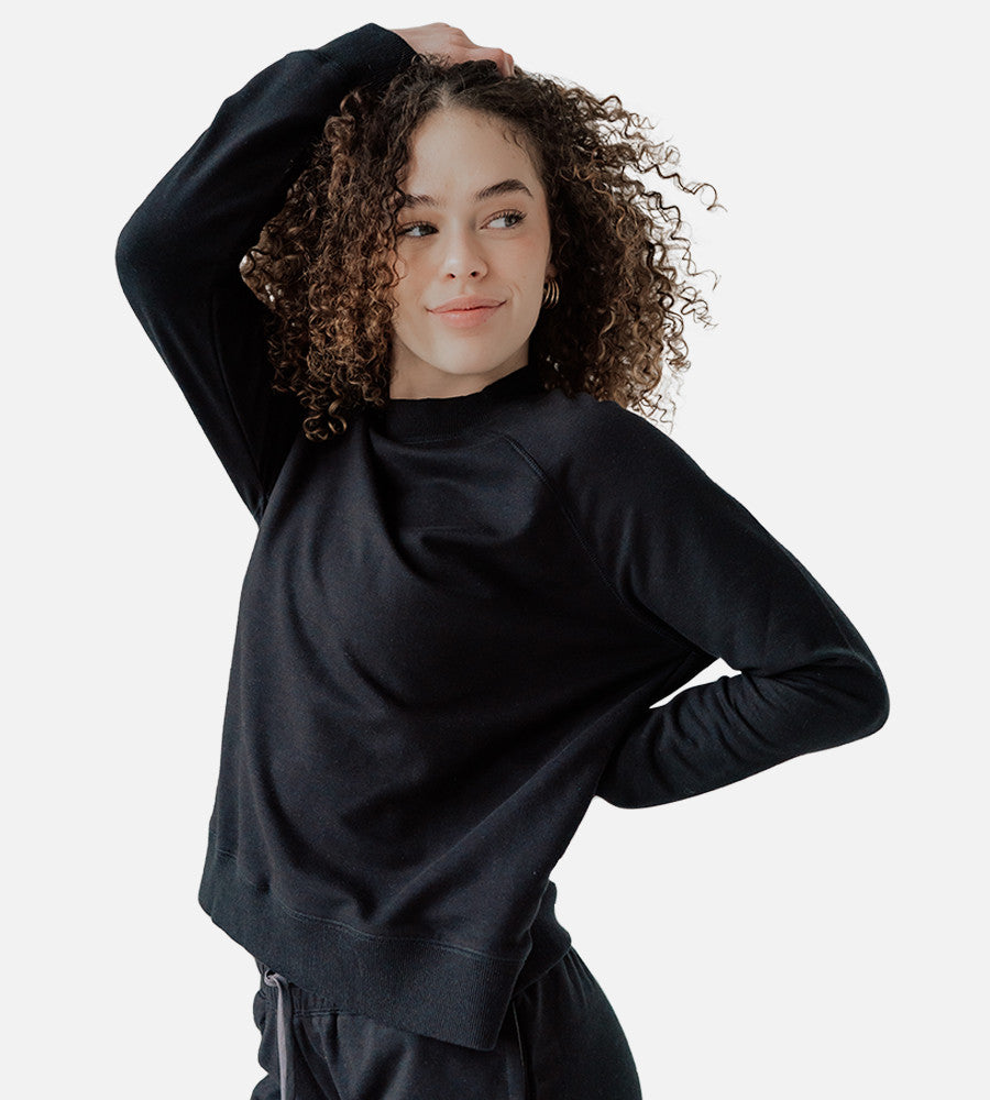 front view of model wearing black pullover sweatshirt