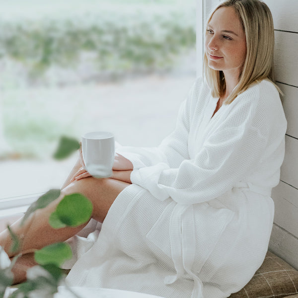 front view of model wearing white waffle knit bathrobe