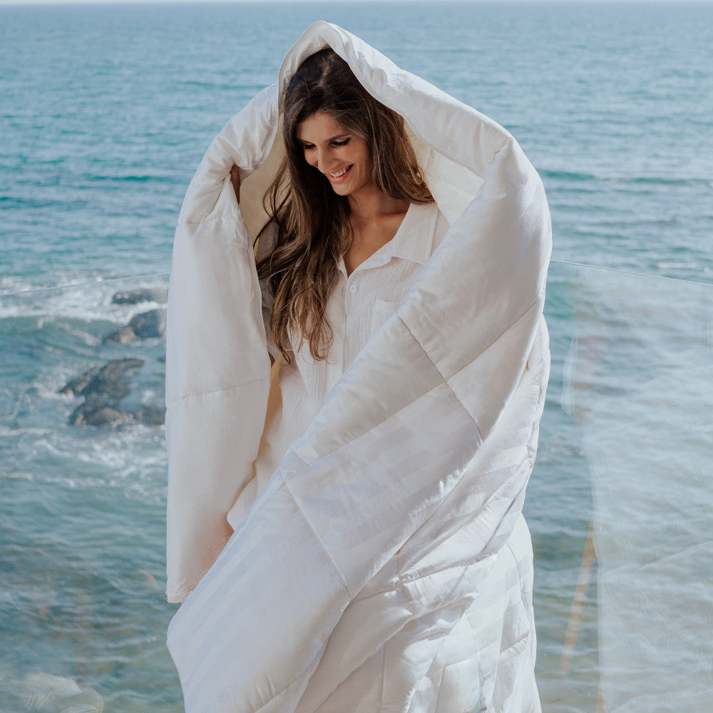 model wrapped in comforter