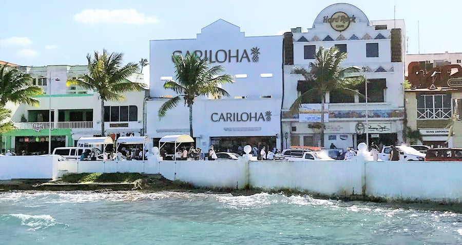 Cariloha storefront on a beachfront boardwalk beside the Hard Rock Cafe