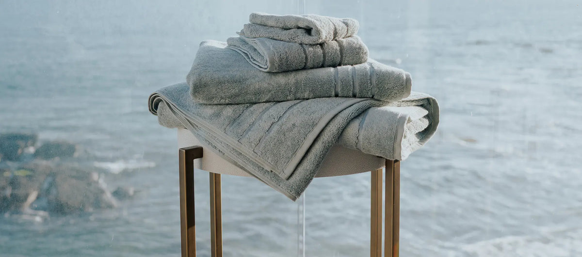a stack of towels on the patio of a beach front home