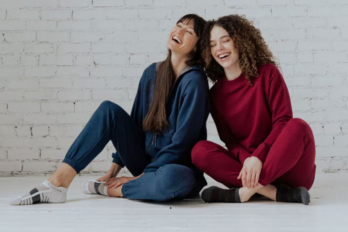 two women wearing blue and red cariloha joggers and jackets