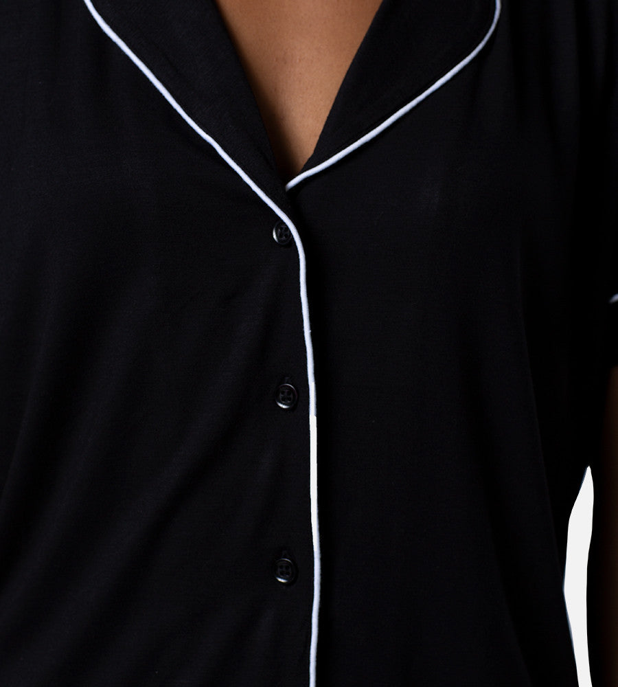close-up on button closure of black sleep set