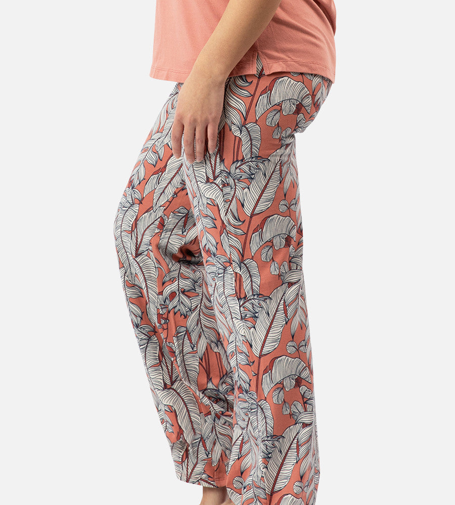 side view of models legs wearing blush foliage print pants