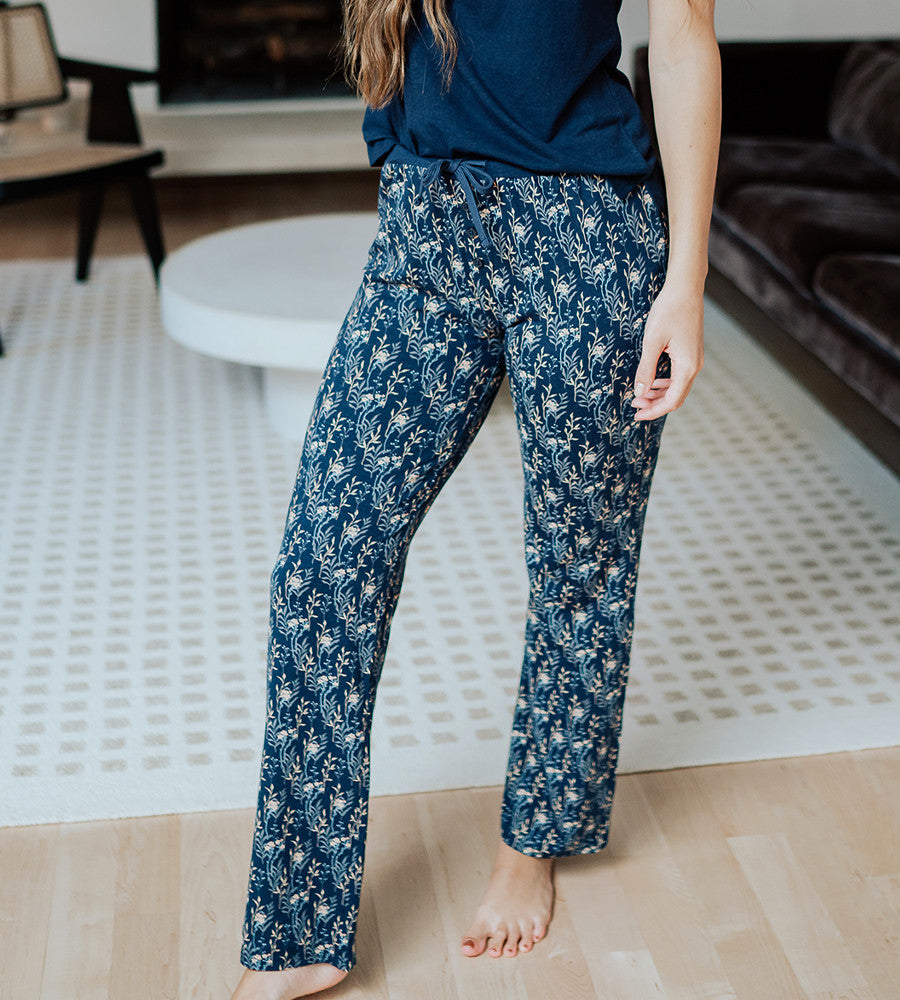 view of models legs wearing midnight floral print pants