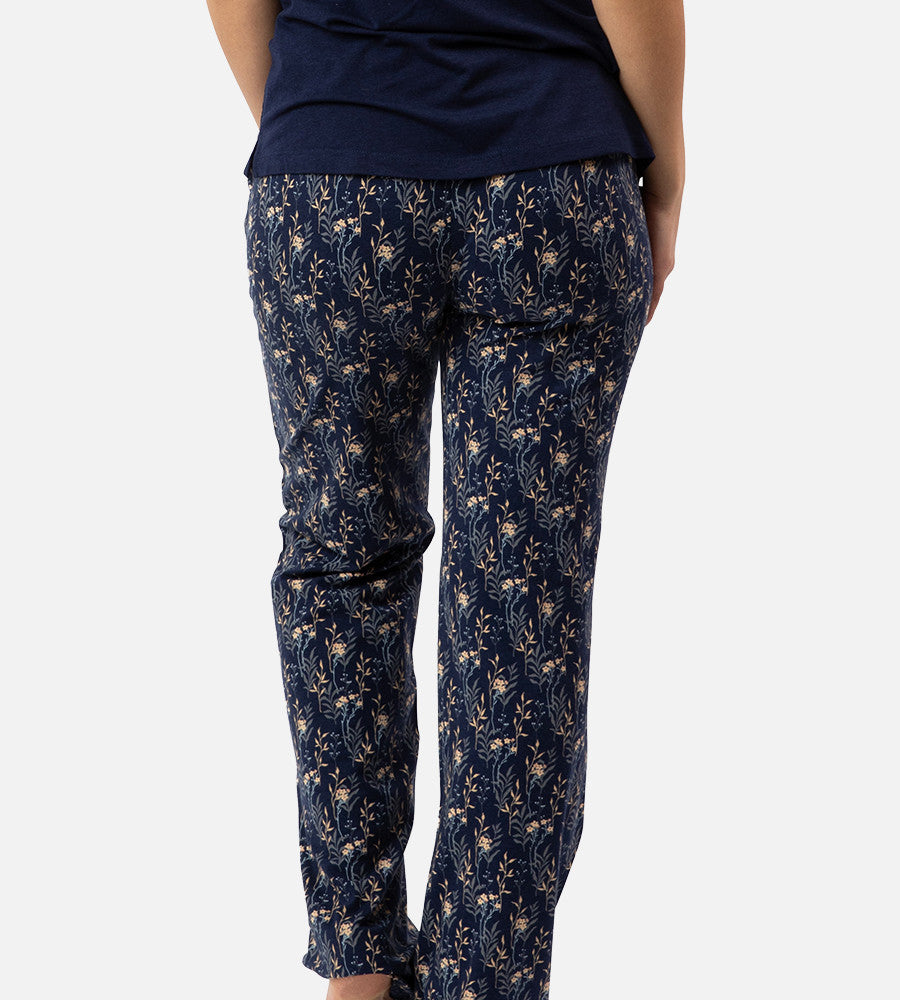 back view of models legs wearing midnight floral print pants
