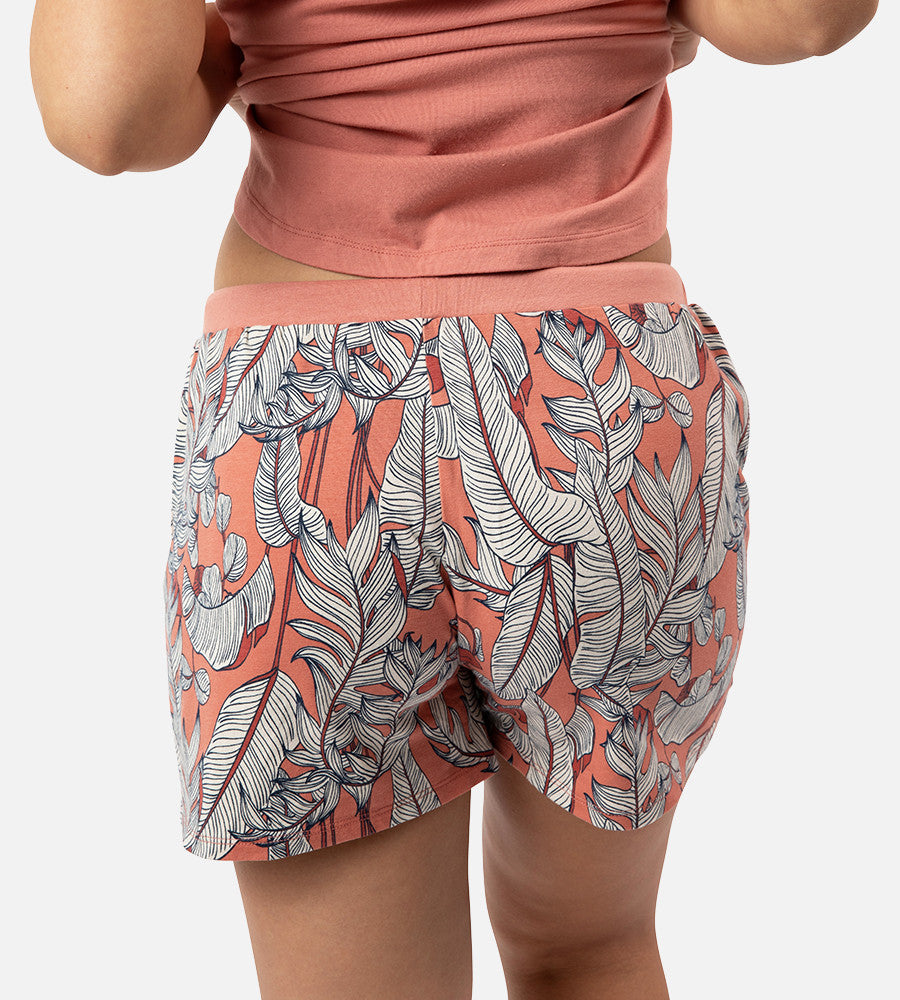 back view of models legs wearing blush foliage print sleep shorts