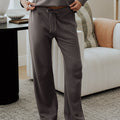 front view of model wearing charcoal pants