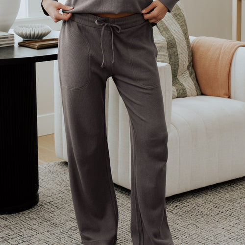 front view of model wearing charcoal pants