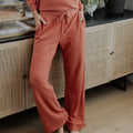 front view of model wearing coral dusk pants