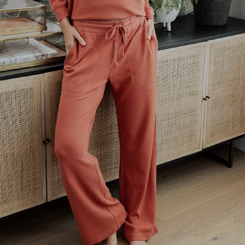 front view of model wearing coral dusk pants