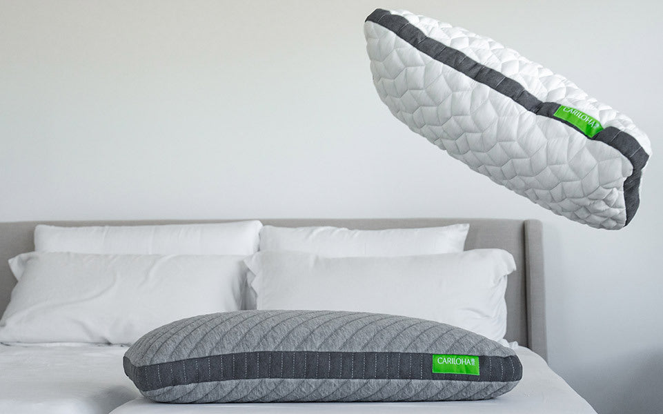 cariloha pillows being thrown onto a bed