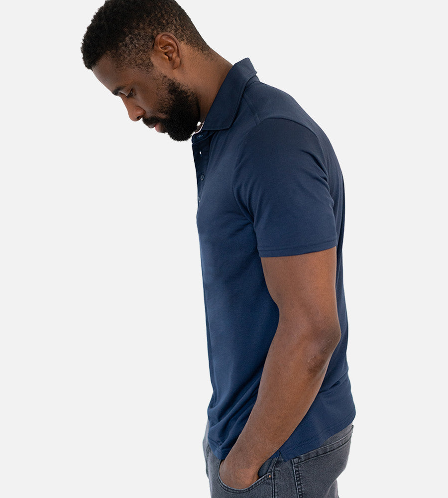 side view of model wearing navy comfort polo~Navy