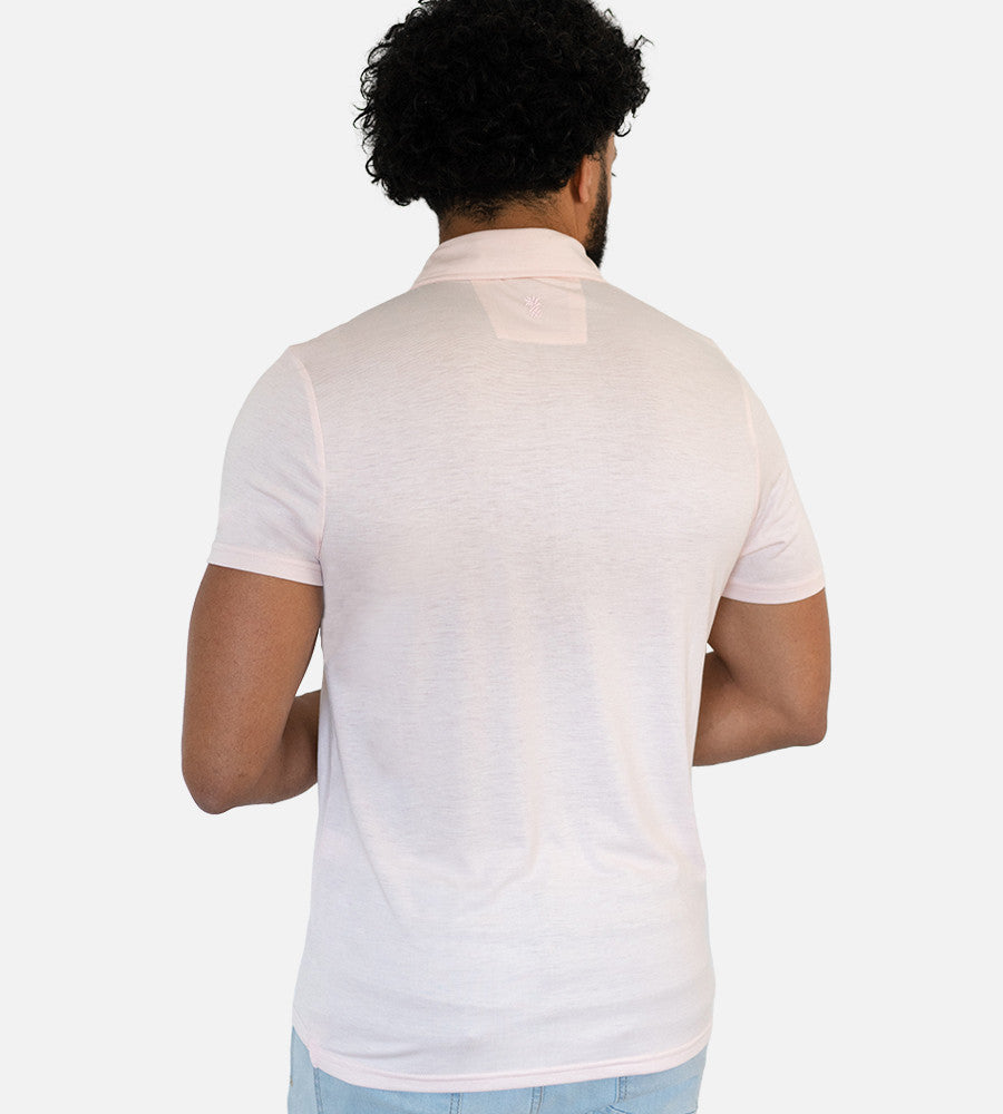 back view of model wearing light pink comfort polo~Light Pink