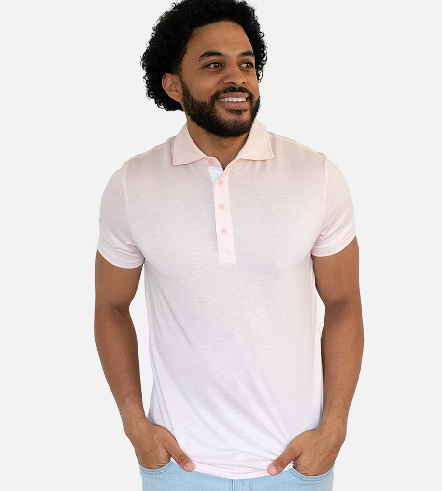 front view of model wearing light pink comfort polo~Light Pink