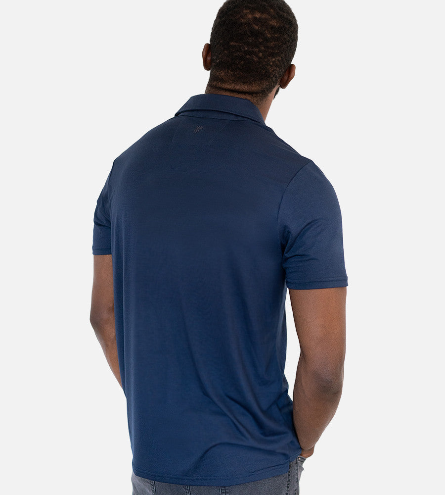 back view of model wearing navy comfort polo~Navy