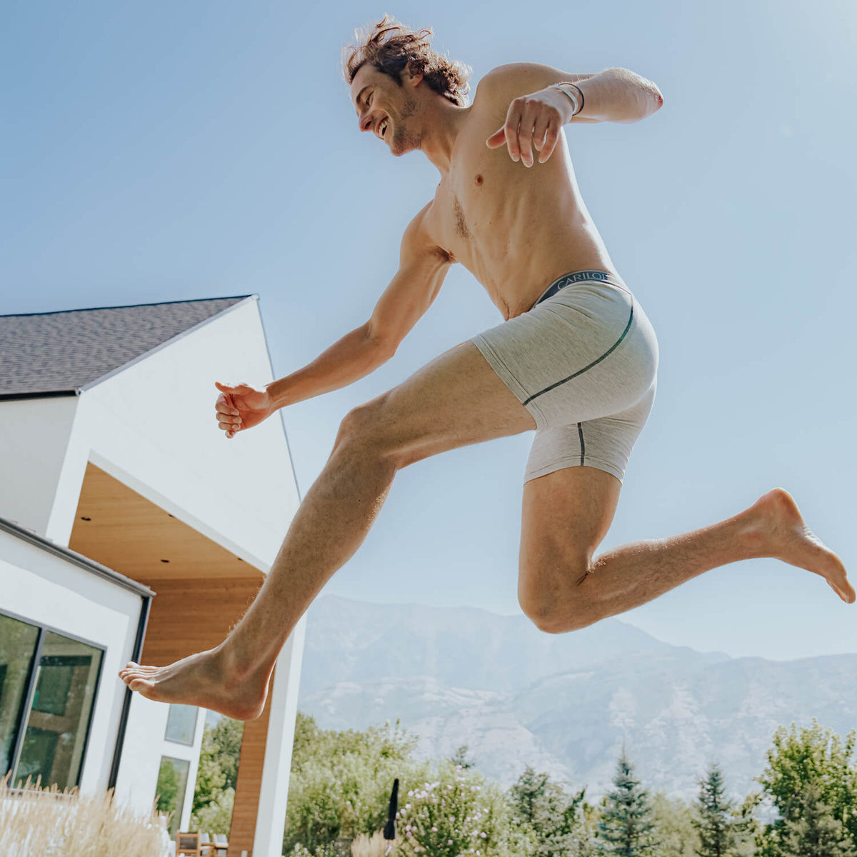 a man wearing light heather gray bamboo boxer briefs.